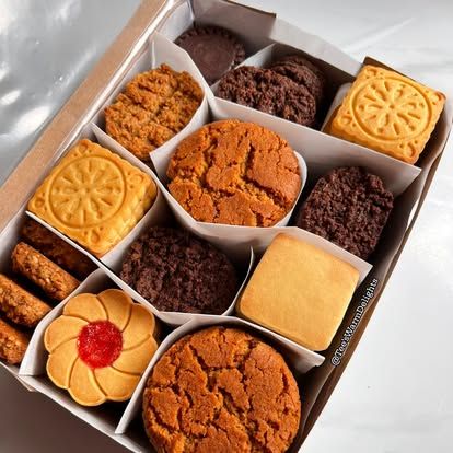 A divided box of assorted biscuits seen from above.