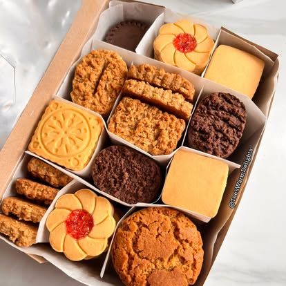 A white divided box of assorted biscuits and cookies.