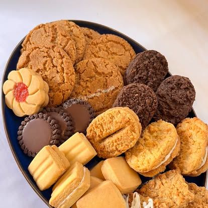 An assorted biscuit platter arranged on a dark blue plate.
