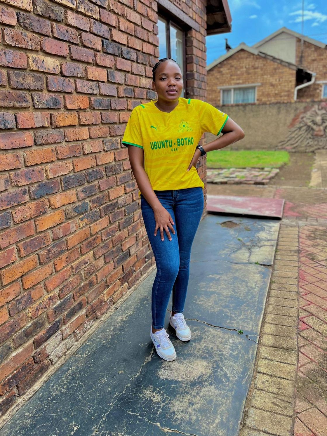 Tiyiselani standing outside her home in Tsakane.