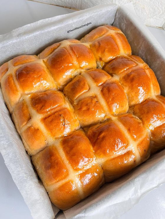A tray of glossy hot cross scones fresh from the oven.