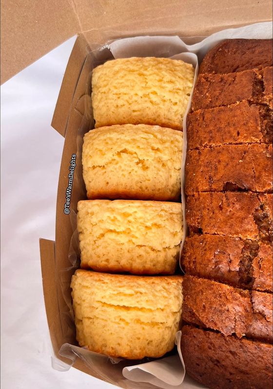 A box holding a sliced vanilla loaf and a chocolate loaf.