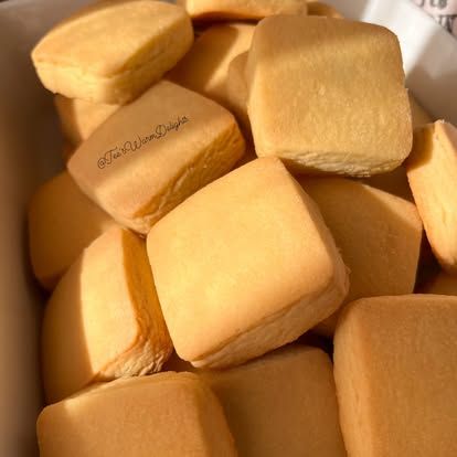 A close-up of soft, pale scones piled together.