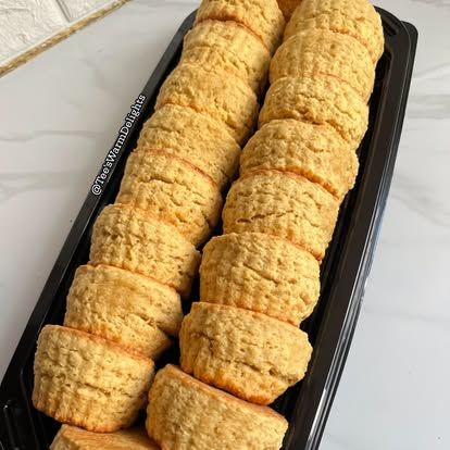 A long tray packed with golden scones.