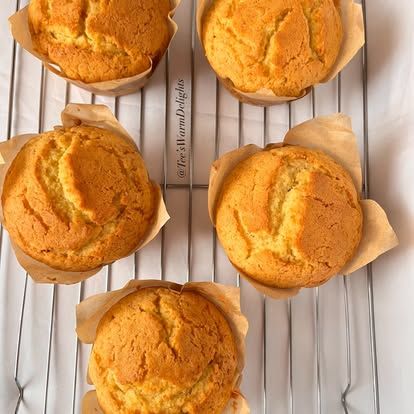 Classic vanilla muffins cooling on a wire rack.